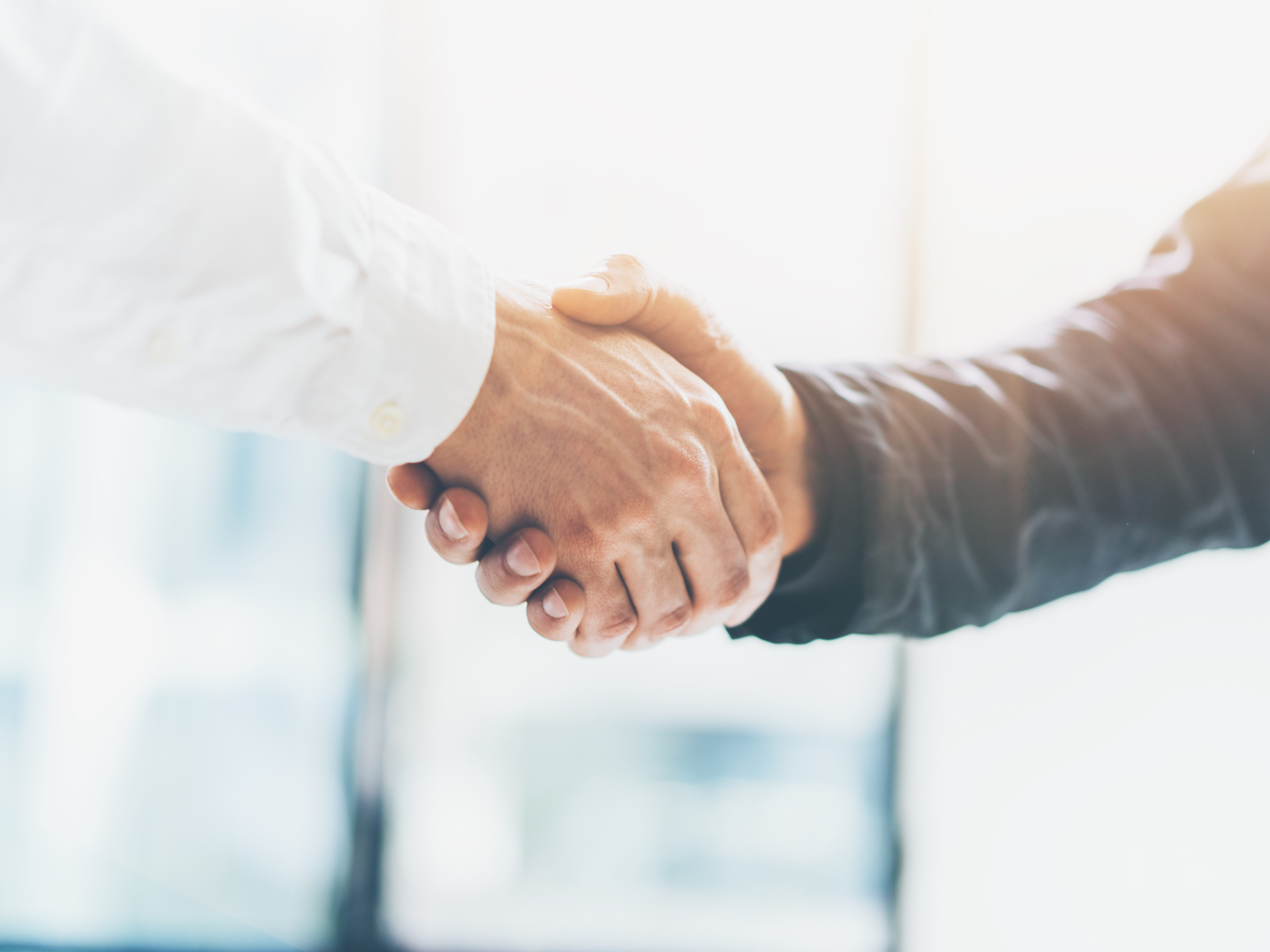 Business partnership meeting. Picture businessmans handshake. Successful businessmen handshaking after good deal. Horizontal, blurred background